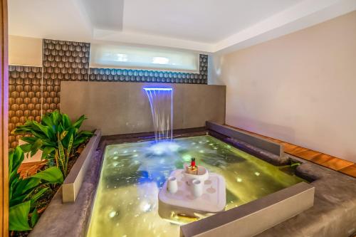 a room with an indoor pool with a water fountain at Alternative Resort & SPA in Scorrano