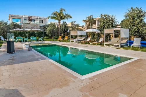 a pool with chairs and umbrellas at a resort at Alternative Resort & SPA in Scorrano