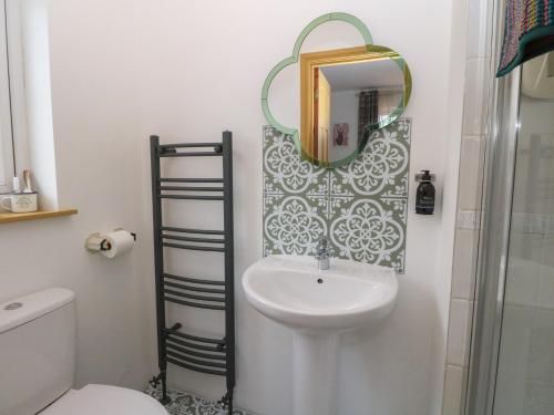 a bathroom with a sink and a mirror at Doire An Daimh in Acharacle