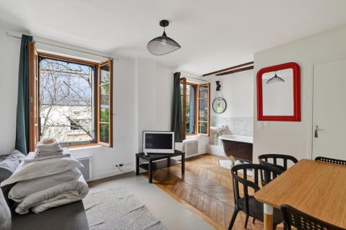 a living room with a table and a dining room at Premium 1BR flat with direct access to the RER B in Gentilly