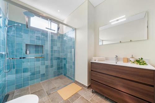 a bathroom with a shower and a sink at Casa da boa vista in Canhas