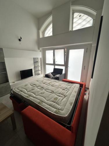 a bedroom with a bed in a room with windows at MILANO Central Station House in Milan