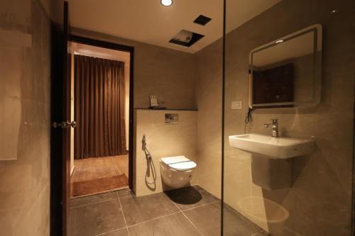 a bathroom with a sink and a toilet and a shower at KG Residency Inn in Thanjāvūr