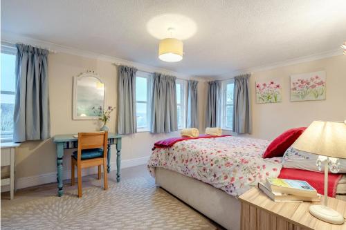 a bedroom with a bed and a desk and windows at 2 Bed in Sandhurst oc-o34807 in Sandhurst