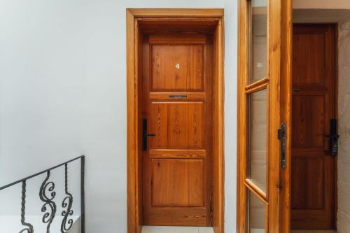 an open wooden door next to a staircase at Suite 4 at Palazzo Seraphim Boutique living in St Julians in St. Julianʼs