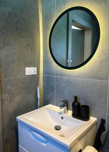 a bathroom with a sink and a mirror at Silva SPA in Goszczyce Średnie