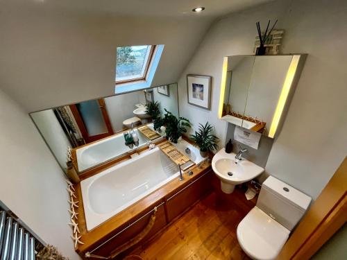 a bathroom with a large tub and a sink at Modern Seaside Townhouse feat Sauna near Brighton in Shoreham-by-Sea