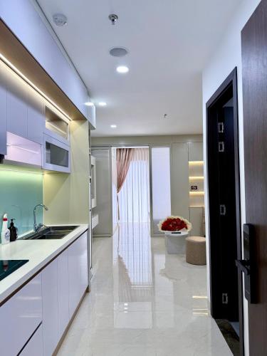 a kitchen with white cabinets and a sink at Phú Tài Central Life in Quy Nhon