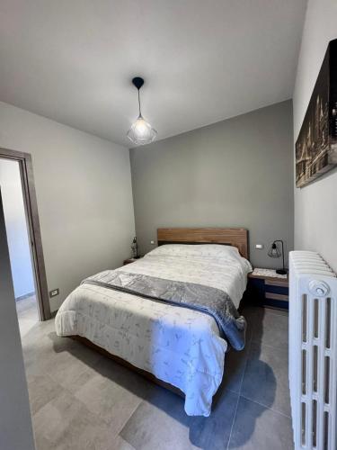 a bedroom with a large bed in a room at The Blue Sky Apartment with Lake view in Pianello Del Lario