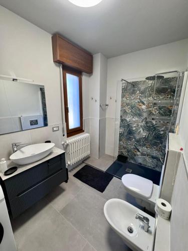a bathroom with two sinks and a shower in it at The Blue Sky Apartment with Lake view in Pianello Del Lario