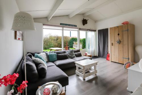 a living room with a couch and a table at Rekerlanden 195 in Schoorldam