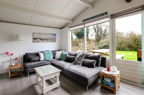 a living room with a couch and a table at Rekerlanden 195 in Schoorldam