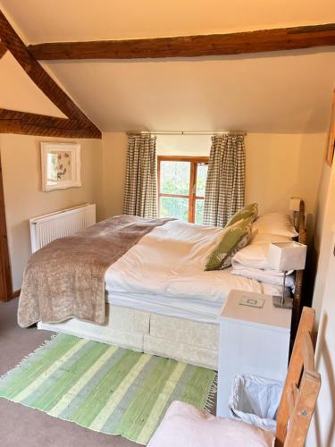 a bedroom with a bed and a window at Llanerch in Bala