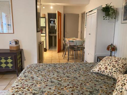 a bedroom with a bed and a dining room at Bel Horizon in La Celle-sous-Gouzon