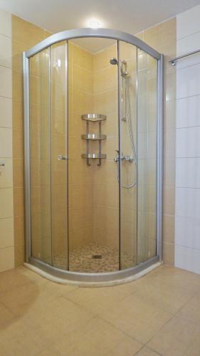 a shower with a glass enclosure in a bathroom at Apartments Obzor Beach C - Апартаменти Обзор Бийч С in Obzor