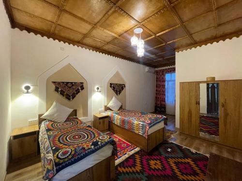 a hotel room with two beds in a room at Anoragul guest house in Shahrisabz