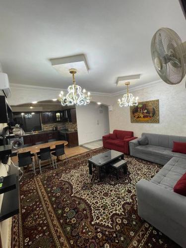 a living room with a couch and a table at Toum's Apartments in Amman