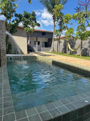 a swimming pool in front of a house at Caminho do mar in Itanhaém