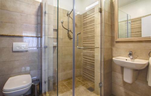 a bathroom with a shower and a toilet and a sink at Executive Residency by Best Western Nairobi in Nairobi