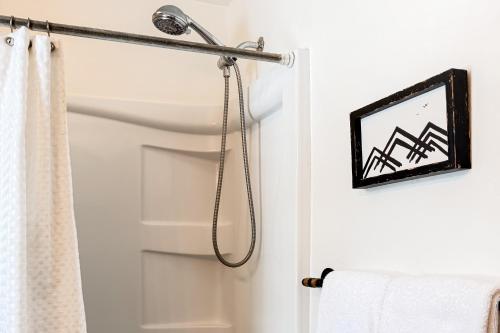 a bathroom with a shower curtain and a door at Shadow Mountain Marina in Grand Lake