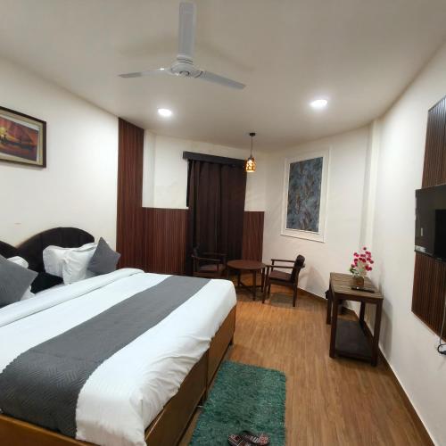 a hotel room with a bed and a table at Ruchi resort in Hisār