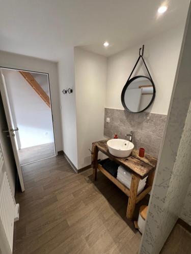 a bathroom with a sink and a mirror at Les Iris - Maison chaleureuse in Montigné-sur-Moine