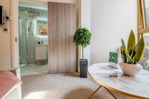 a room with a table and a sliding door at Luxe London Retreat by Aureva Residences in London