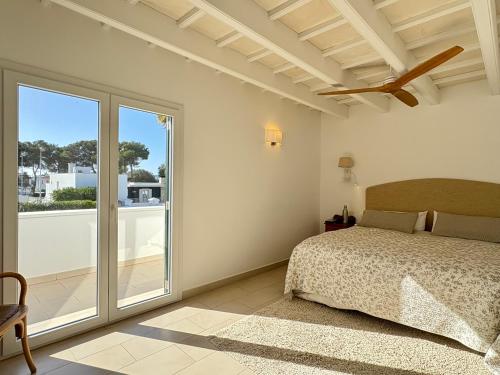 a bedroom with a bed and a large window at Bella Mar in Son Carrio