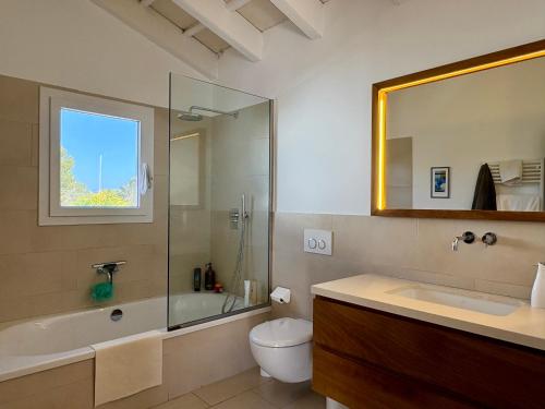 a bathroom with a toilet and a shower and a sink at Bella Mar in Son Carrio