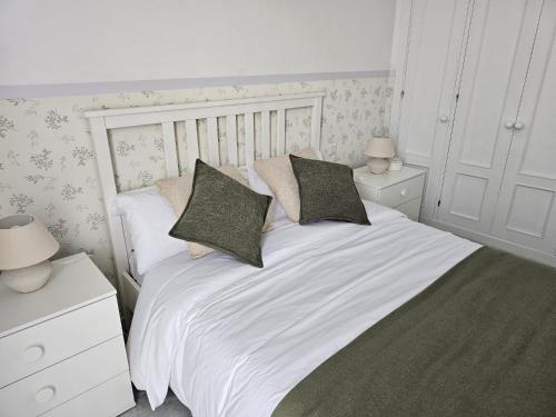 a bedroom with a white bed with two pillows at Solo or Couple , Solo o Pareja in Seville