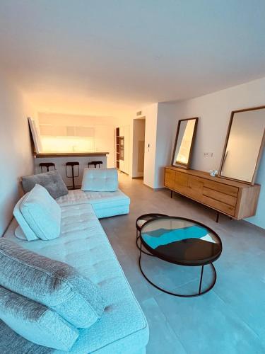 a room with two beds and a table and mirrors at Rare T2 New, Waterfront in Porticcio