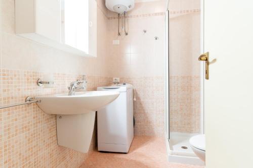a bathroom with a sink and a toilet at Residence Selenis Apartments in Caorle