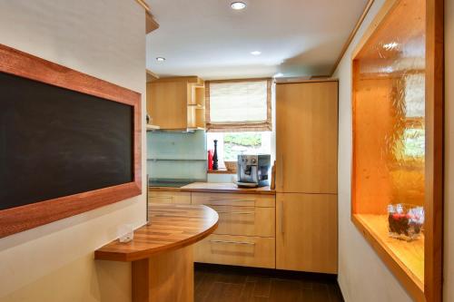 a kitchen with a large flat screen tv on a wall at Alpenhaus Montafon by Pferd auf Wolke in Gargellen