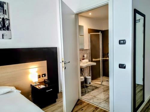 a hotel room with a bed and a bathroom at Hotel Carpi in Carpi