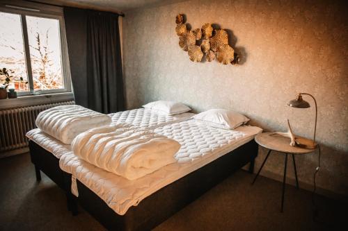 a large bed in a bedroom with a window at Gårdshuset på Wrågården in Falköping