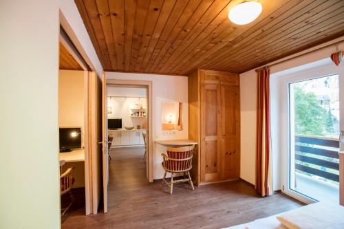 a room with a table and a desk with a window at Alpenhaus Montafon by Pferd auf Wolke in Gargellen