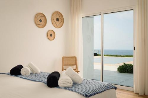 a bedroom with a bed with towels on it at Casa do Mar - North Coast Ocean Views in Calhetas