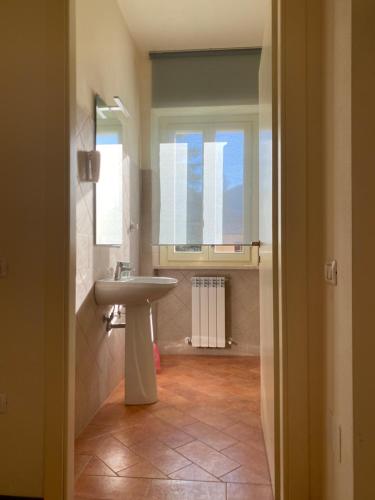 a bathroom with a sink and a window at Casa Rasiglia 2 House Smart in Casenove