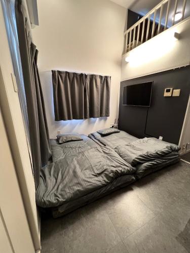 a large bed in a room with a bunk bed at イマココホテル in Yogi