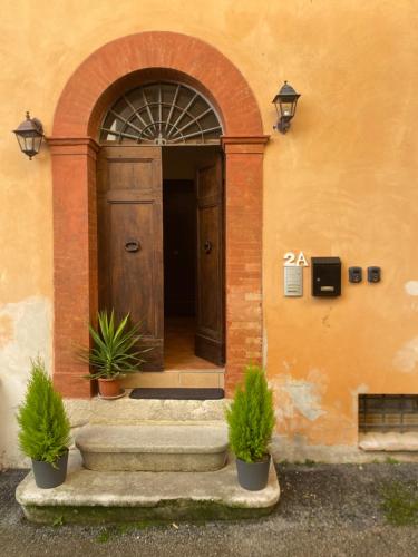 an entrance to a building with a wooden door at Casa Rasiglia 2 House Smart in Casenove