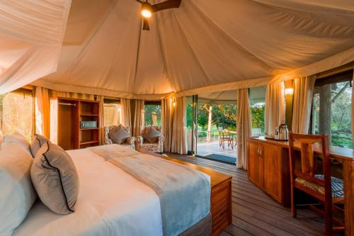 a bedroom with a large bed in a tent at Mutsviri Game Lodge in Victoria Falls