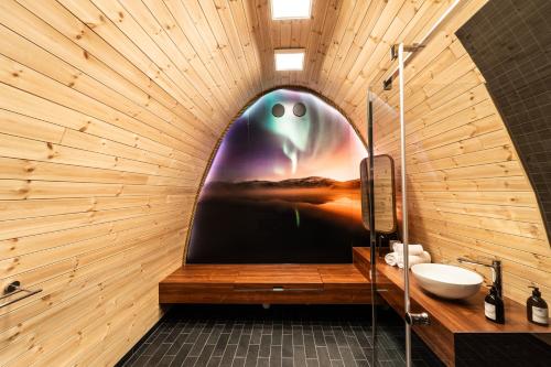 a bathroom with a wall with a large painting of an eye at Snow Resort Kirkenes in Kirkenes