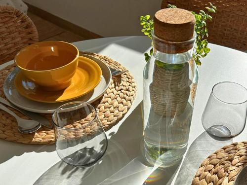 a table with a bottle of water and glasses on it at Il Colle in Buia