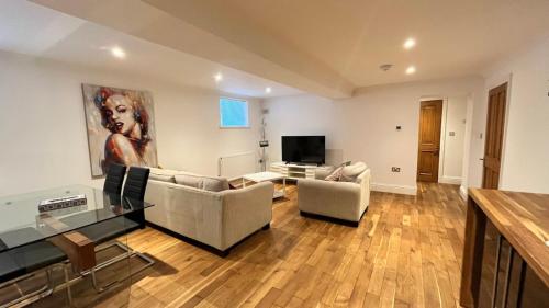 a living room with two couches and a television at Flat 1- The Marilyn in Banbury