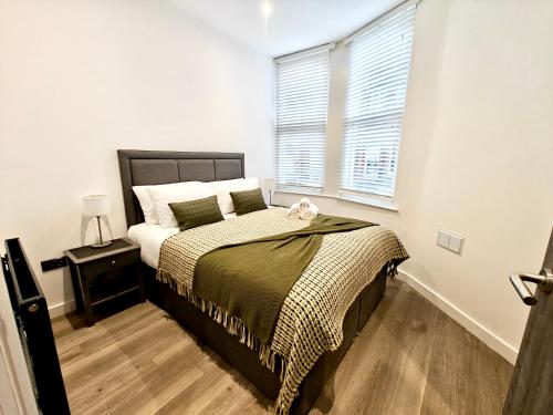 a bedroom with a bed and a window at Executive 1-Bed Apartment in Town in Bury
