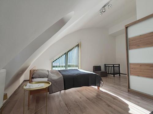 a bedroom with a bed and a large window at Srce Fojnice in Fojnica