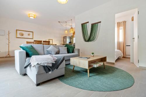 a living room with a couch and a table at Hauzify I Casa Olivella A in Olivella