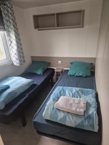 a bedroom with two beds and a window at Mobil-Home L'Escale-MH34 Les Sables du Midi in Sérignan