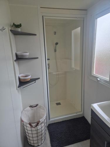 a bathroom with a shower and a glass shower stall at Mobil-Home L'Escale-MH34 Les Sables du Midi in Sérignan