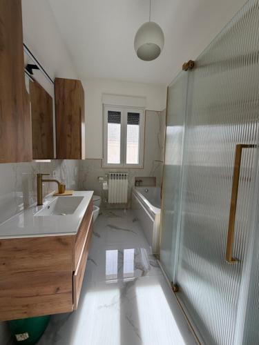 a bathroom with a shower and a sink and a tub at Apartment Rino 1 Caorso in Caorso